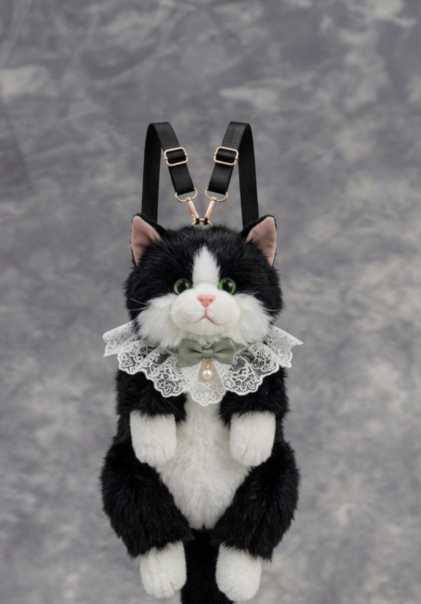 Plush toy cat with suspenders and a lace collar on a gray background
