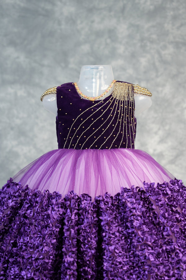 Deep Plum with light purple Frock for Baby Girls Rich velvet bodice with stunning diagonal gold bead embroidery, lavender tulle waist & fully bloomed purple rosette skirt. Ideal for birthdays & parties