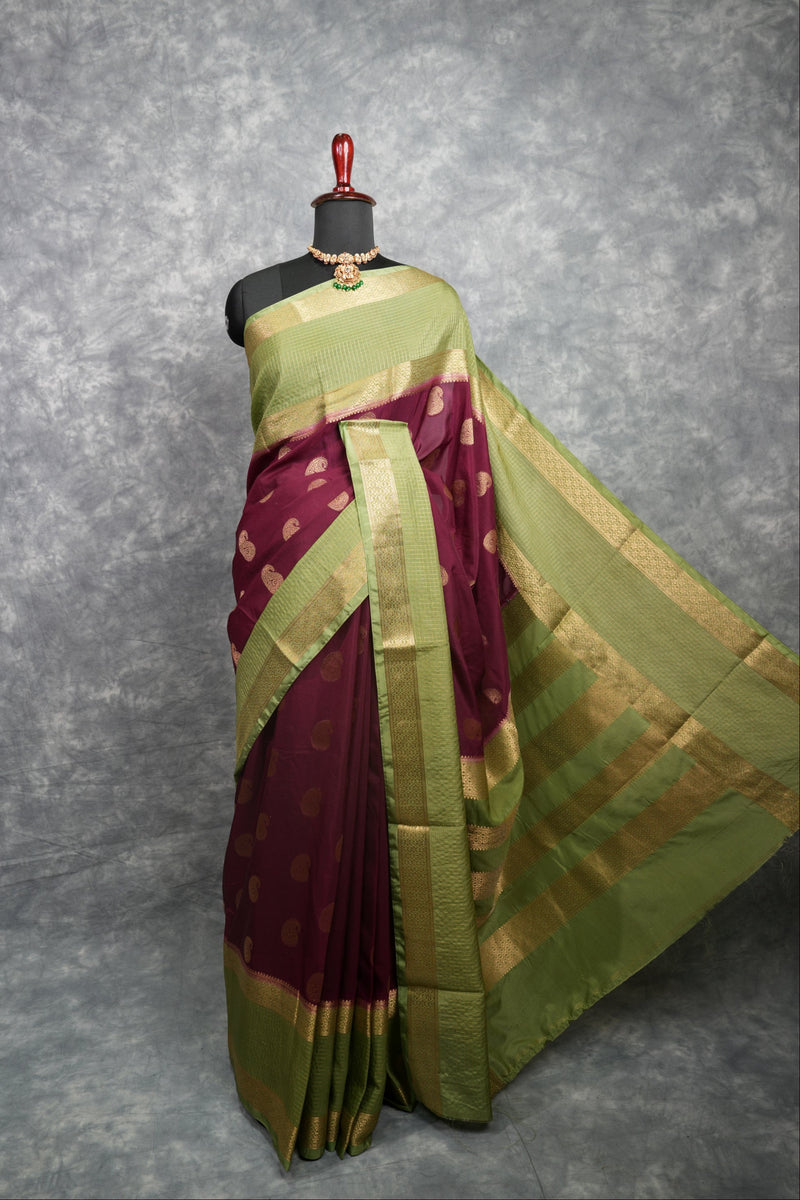 Saree with purple and green pattern on a mannequin against a gray background