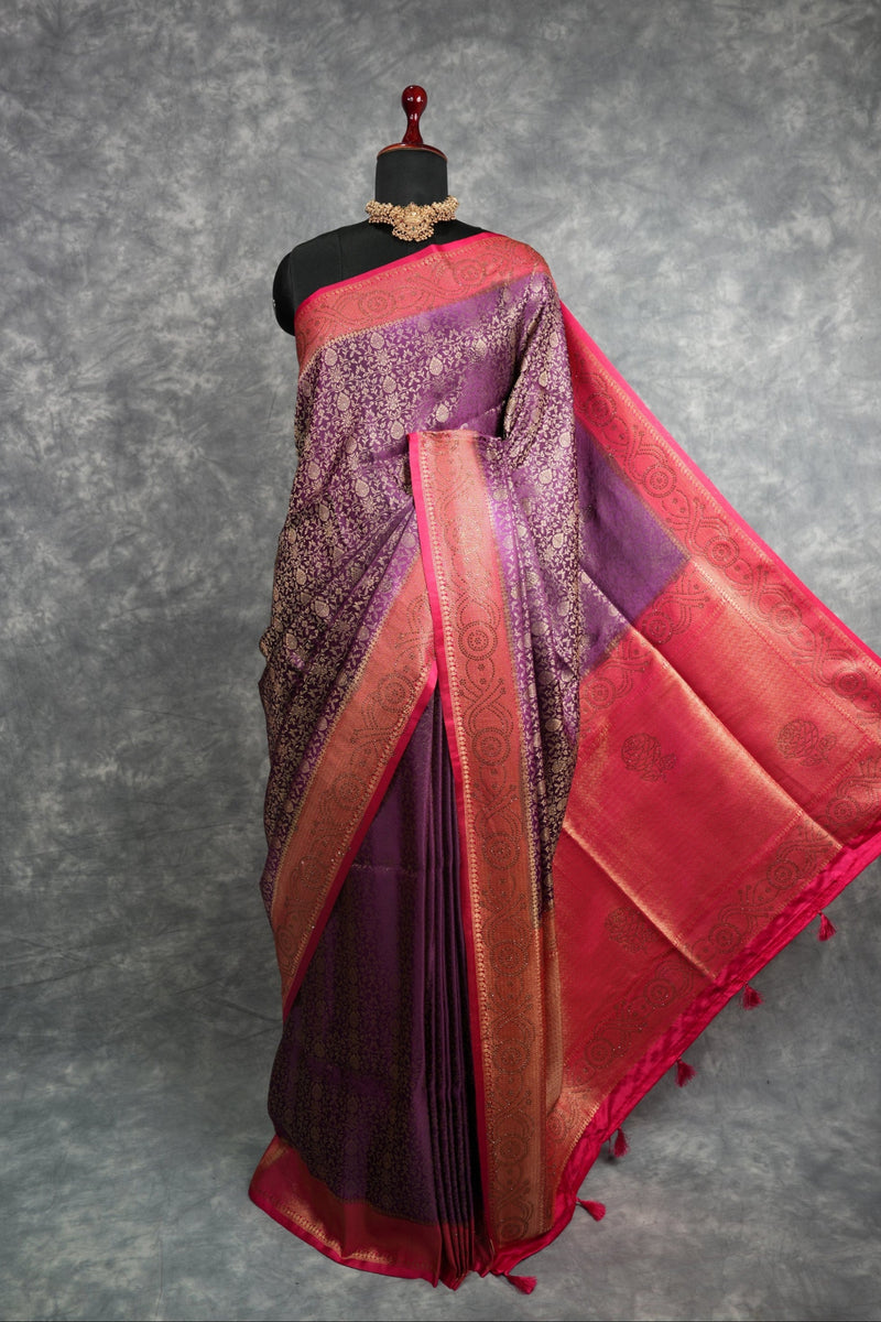Saree with purple and red patterns on a mannequin against a gray background