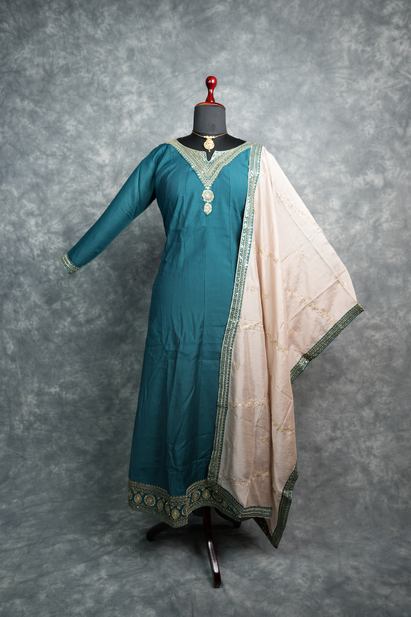 Deep Teal Anarkali Churidar Set - Stunning deep teal silk anarkali with gold zari embroidery, sequin work & rich embellished borders. A graceful, festive pick for weddings & celebrations.
