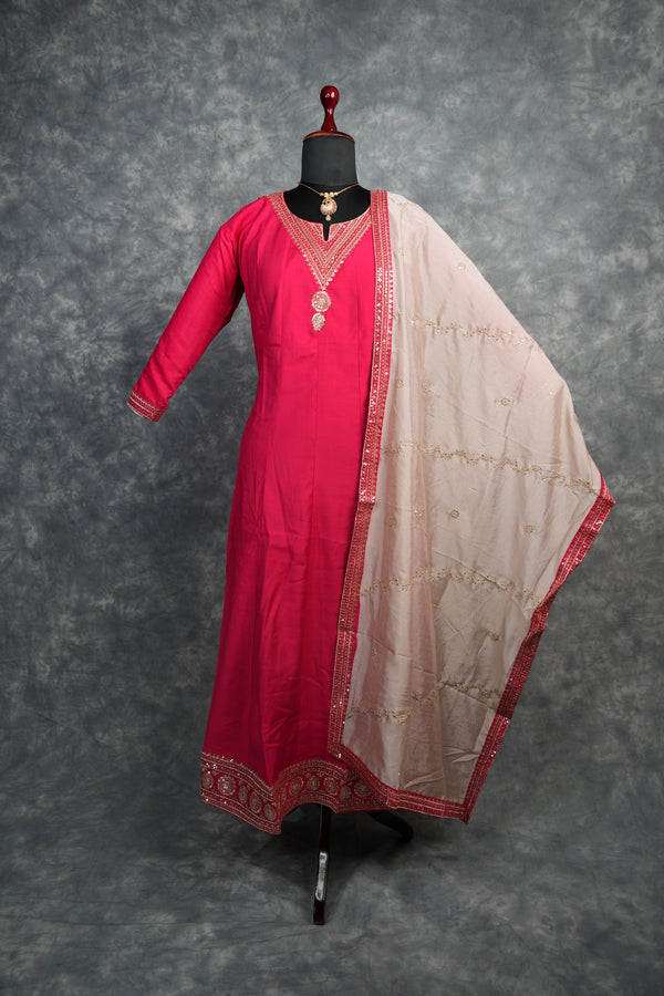 Rani Pink Anarkali Churidar Set – Rich silk elegance with intricate gold zari work, sequin embellishments, and detailed borders, creating a graceful and eye-catching ethnic look.