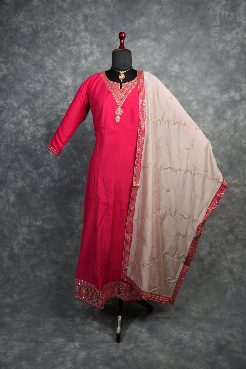 Rani Pink Anarkali Churidar Set – Rich silk elegance with intricate gold zari work, sequin embellishments, and detailed borders, creating a graceful and eye-catching ethnic look.