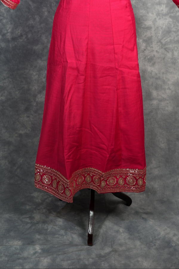 Rani Pink Anarkali Churidar Set – Rich silk elegance with intricate gold zari work, sequin embellishments, and detailed borders, creating a graceful and eye-catching ethnic look.