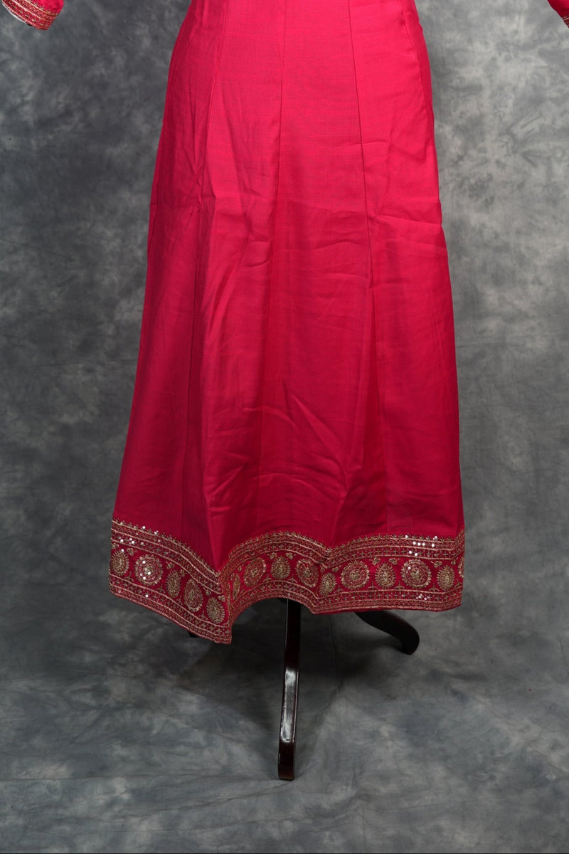 Rani Pink Anarkali Churidar Set – Rich silk elegance with intricate gold zari work, sequin embellishments, and detailed borders, creating a graceful and eye-catching ethnic look.