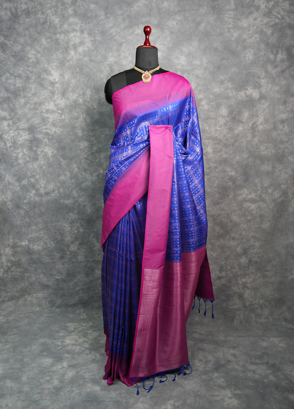 Blue and pink saree on a mannequin against a gray background