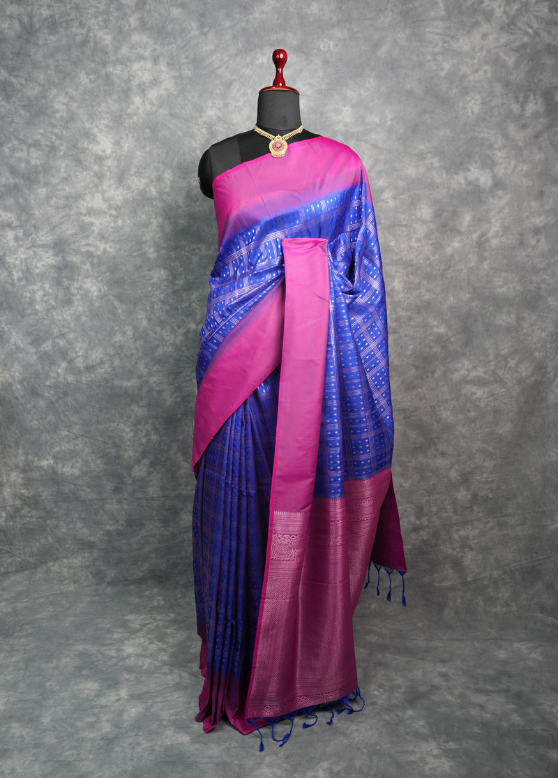 Blue and pink saree on a mannequin against a gray background