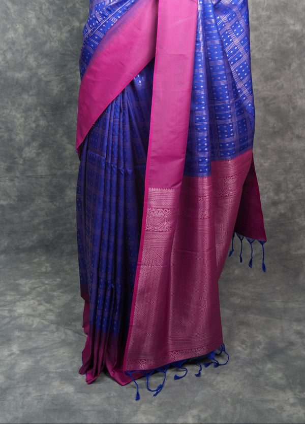 Blue and pink saree on a mannequin against a gray background