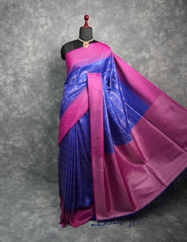Blue and pink saree on a mannequin against a gray background