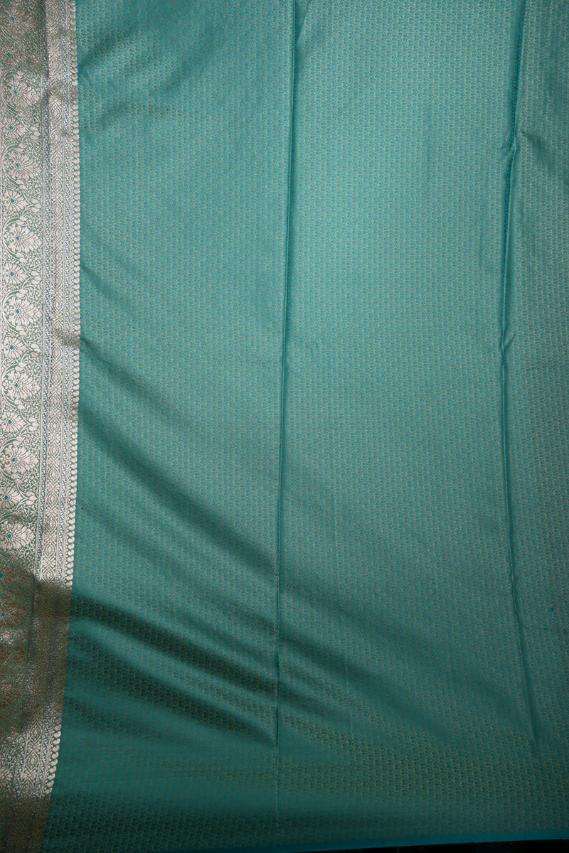 Teal fabric with a subtle pattern on a plain background