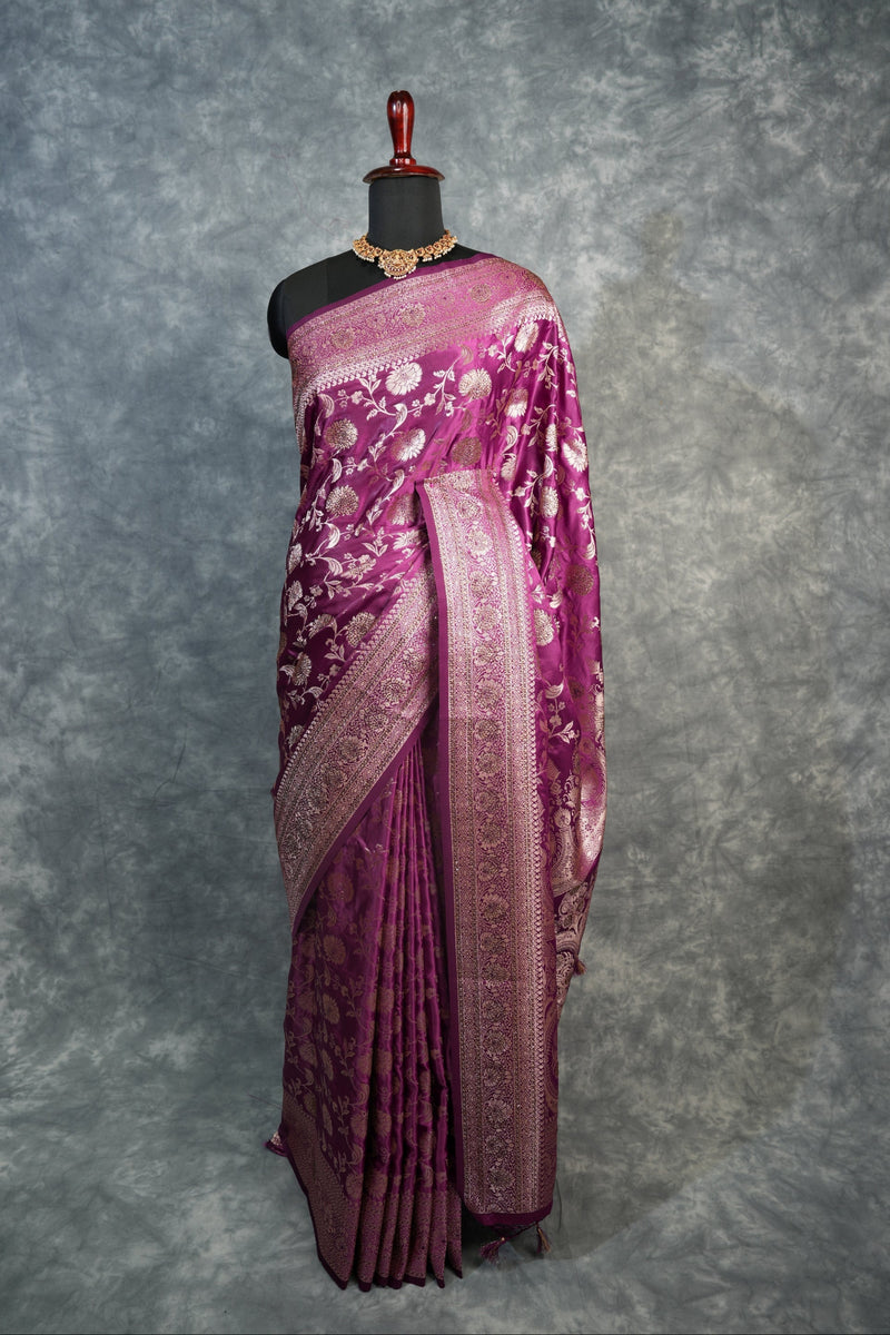 Purple fabric with intricate patterns on a textured gray background