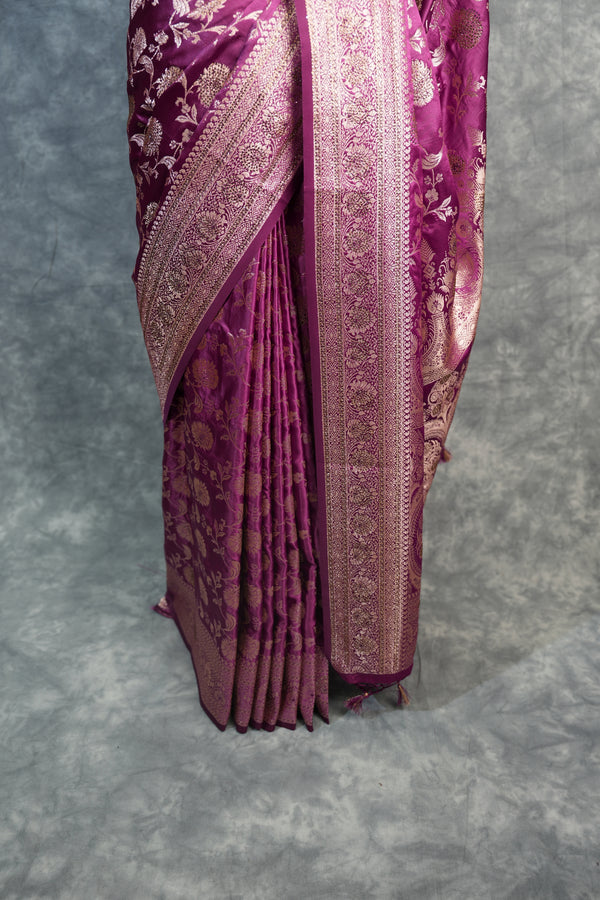 Folded purple fabric with intricate patterns on a gray background