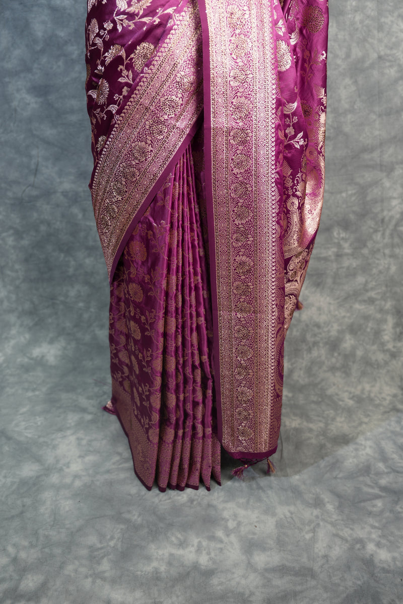 Folded purple fabric with intricate patterns on a gray background