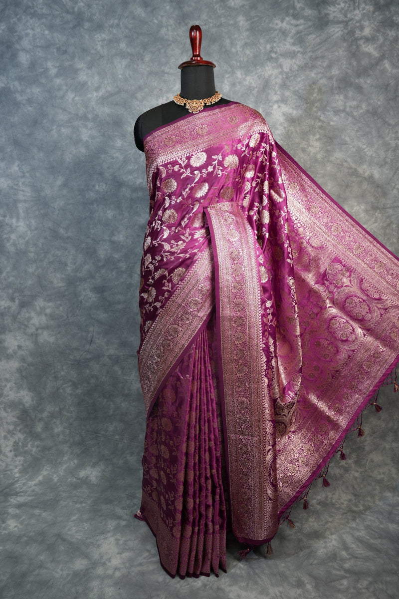 Pink embroidered fabric on a textured gray background