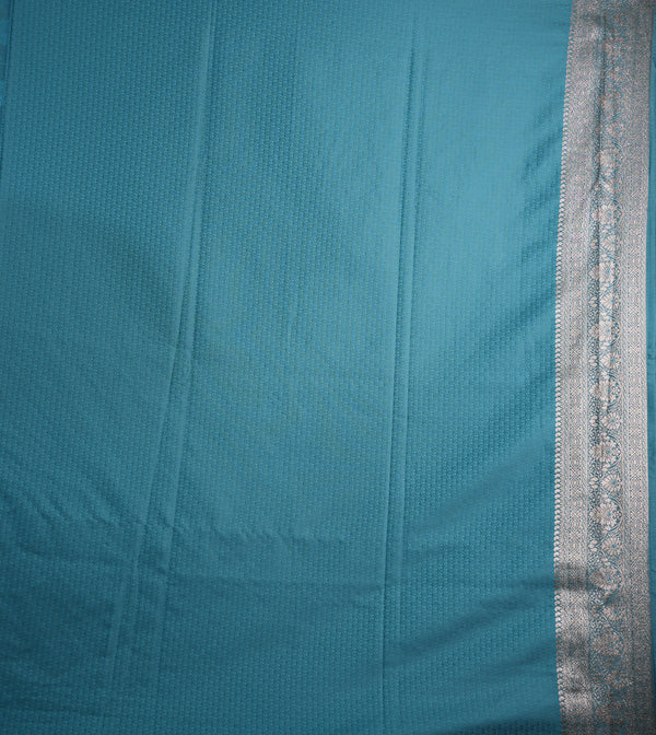 Teal fabric with a silver border