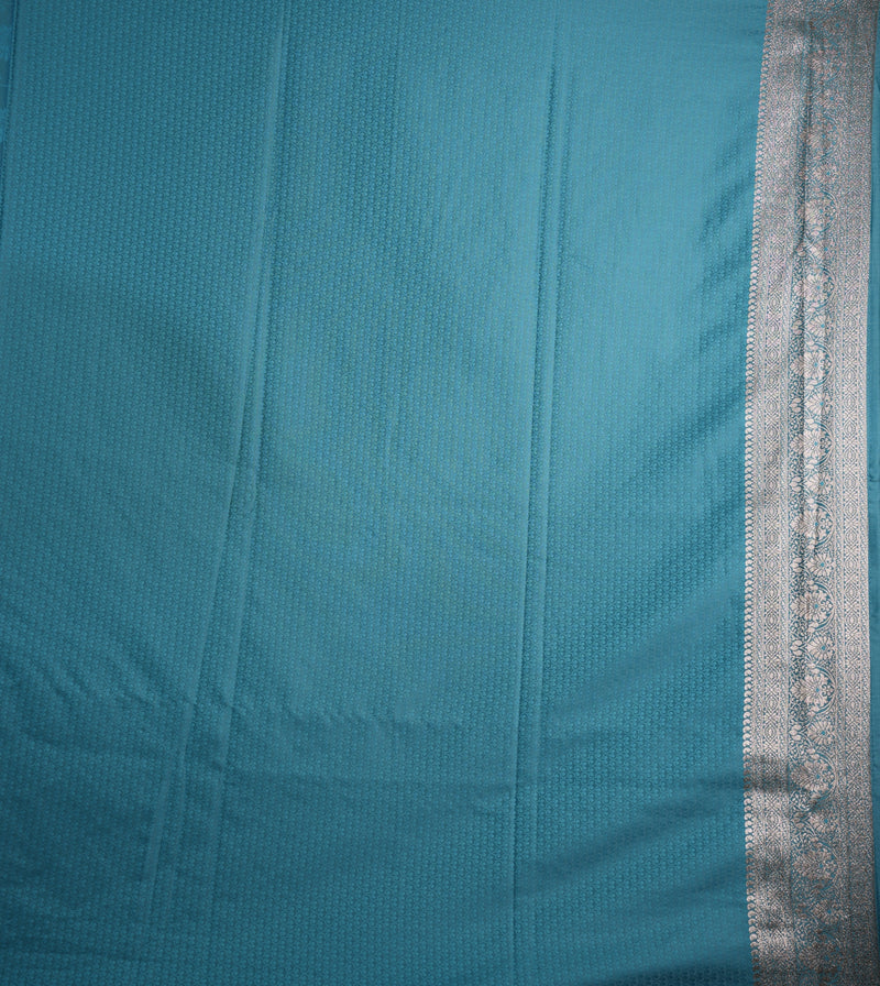 Teal fabric with a silver border