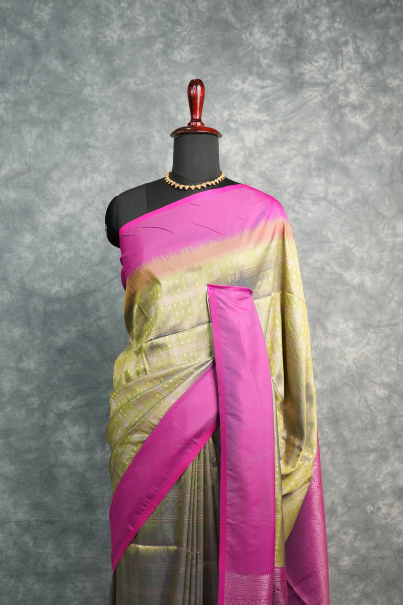 Traditional outfit with a pink and gold sash on a gray background