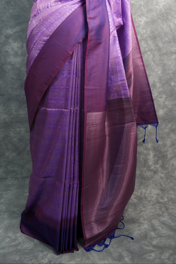 Purple saree on a mannequin against a gray background