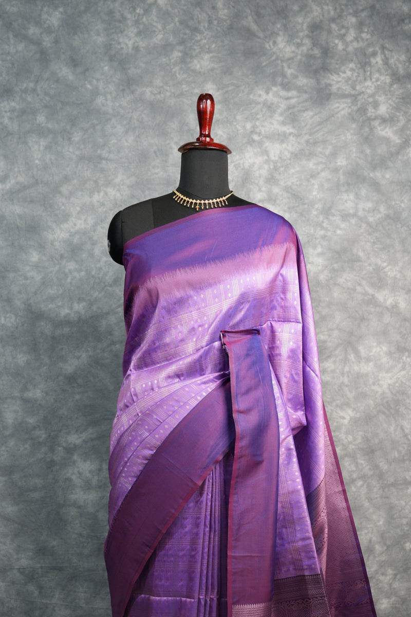 Purple saree on a mannequin against a gray background