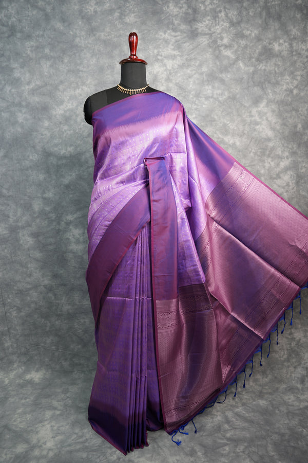 Purple saree on a mannequin against a gray background