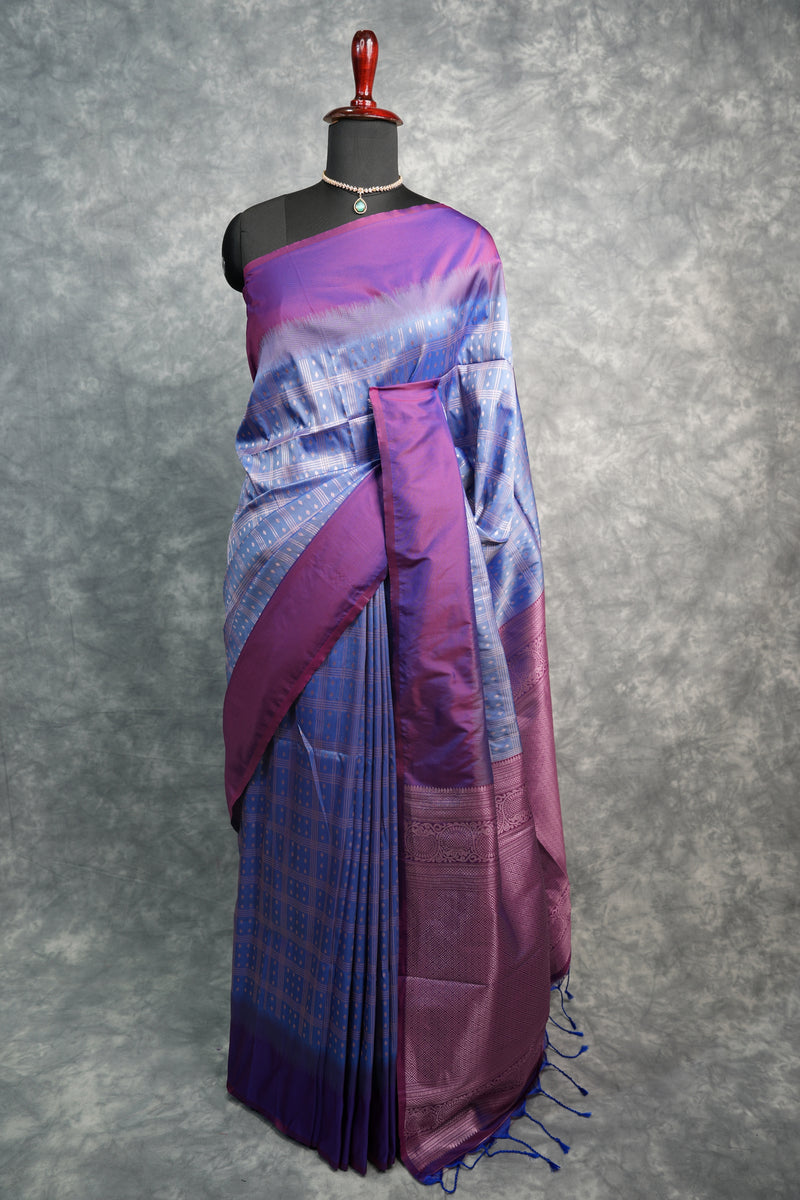 Purple and blue saree on a mannequin against a gray background