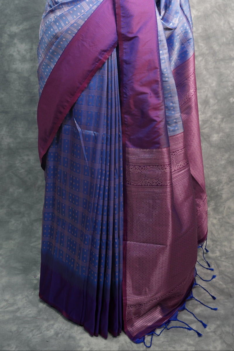 Purple and blue saree on a mannequin against a gray background