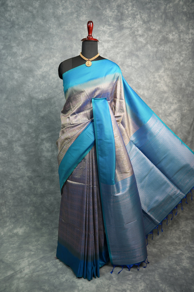 Blue and gray saree on a mannequin against a gray background