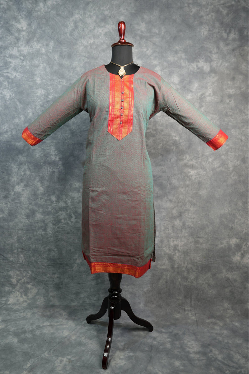 Gray and red jumpsuit on a mannequin against a gray background