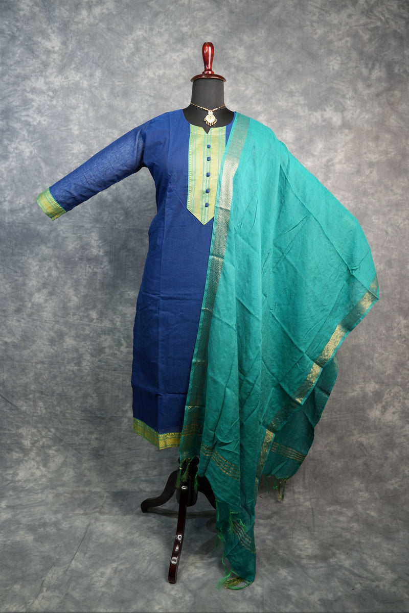 Blue and green fabric on a stand against a gray background