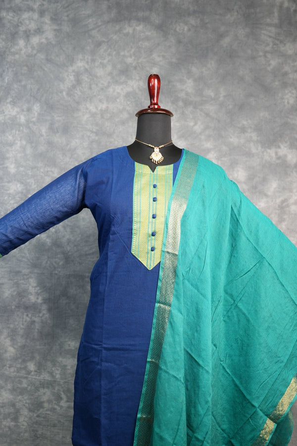 Blue and green fabric on a stand against a gray background