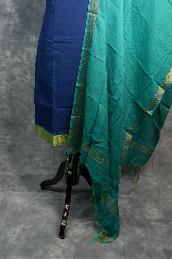 Blue and green fabric on a stand against a gray background