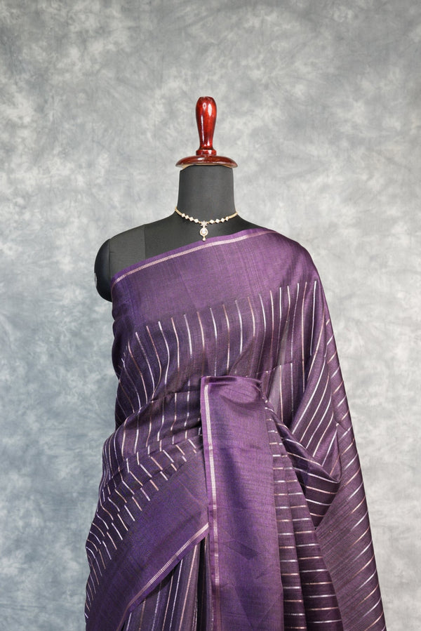 Purple saree with white stripes on a mannequin against a gray background