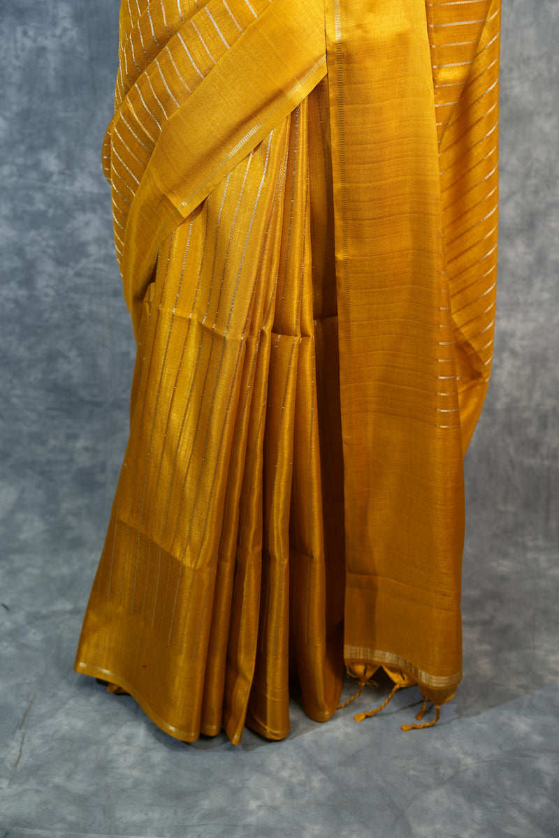 Yellow pleated fabric on a gray background