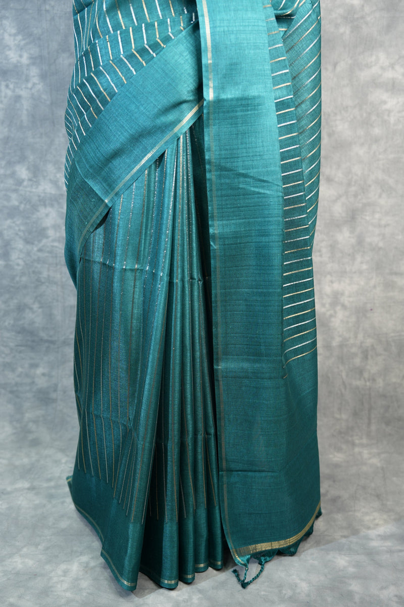 Folded green fabric on a gray background
