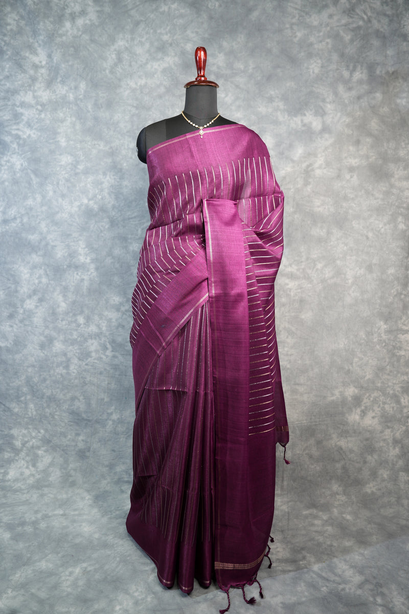 Purple saree with white patterns on a mannequin against a gray background