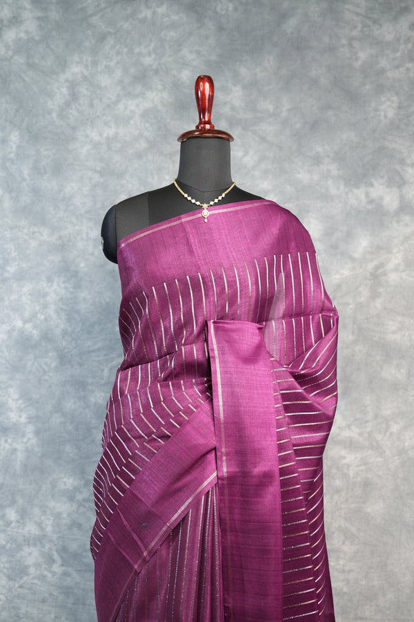 Purple saree with white patterns on a mannequin against a gray background
