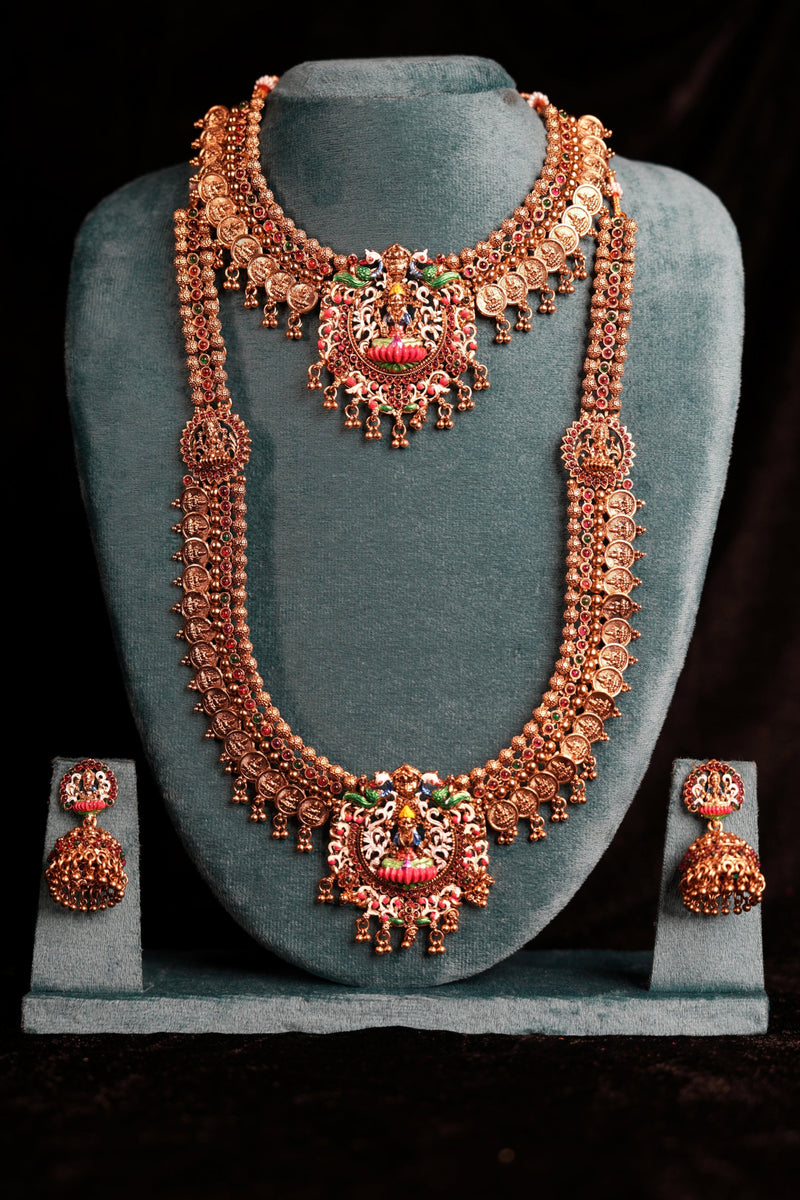 Ornate necklace set with matching earrings on a black background