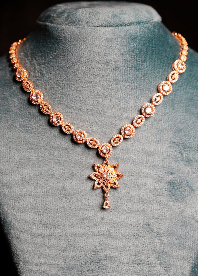 Necklace with a pendant on a gray velvet stand against a black background