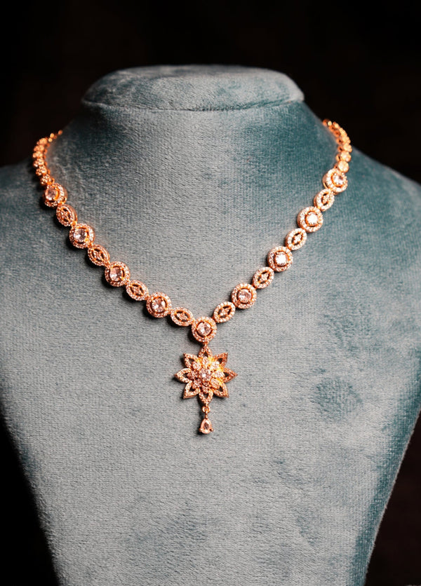 Necklace with a pendant on a gray velvet stand against a black background