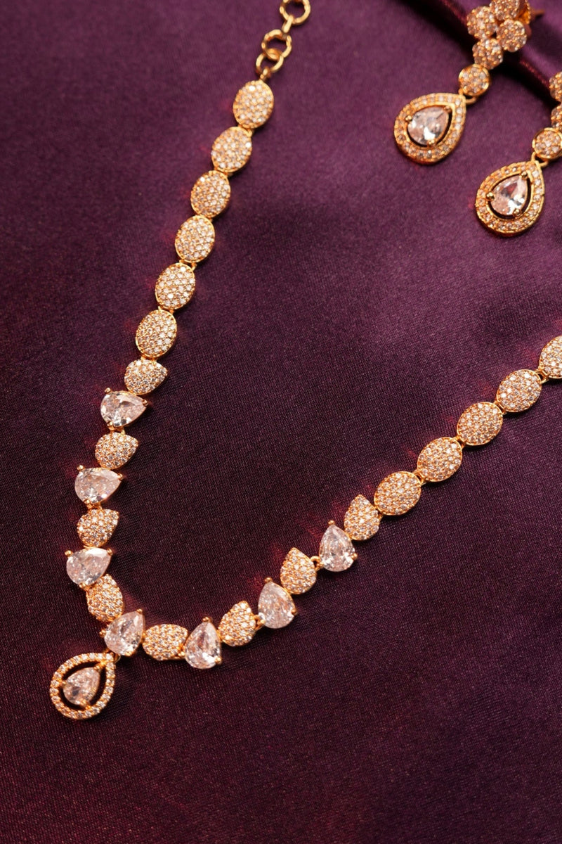 Gold bracelet with diamond accents on a purple fabric background