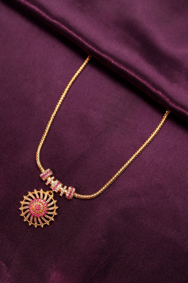 Decorative headband with pink and gold elements on a purple fabric background