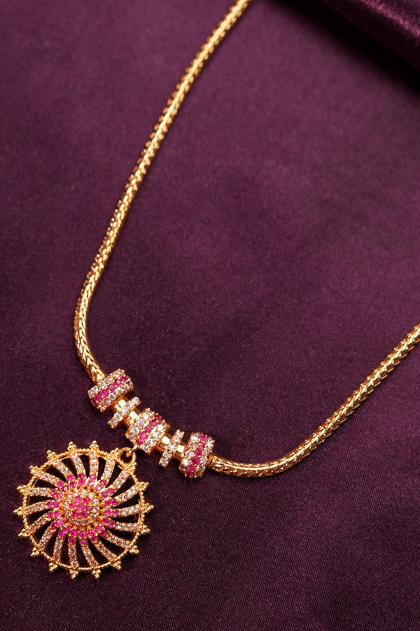 Decorative headband with pink and gold elements on a purple fabric background