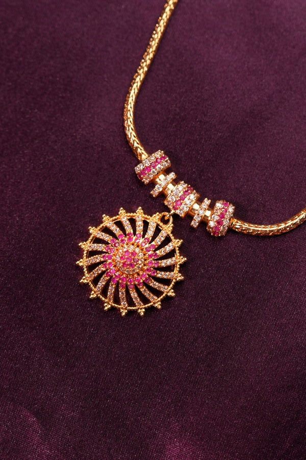 Decorative headband with pink and gold elements on a purple fabric background