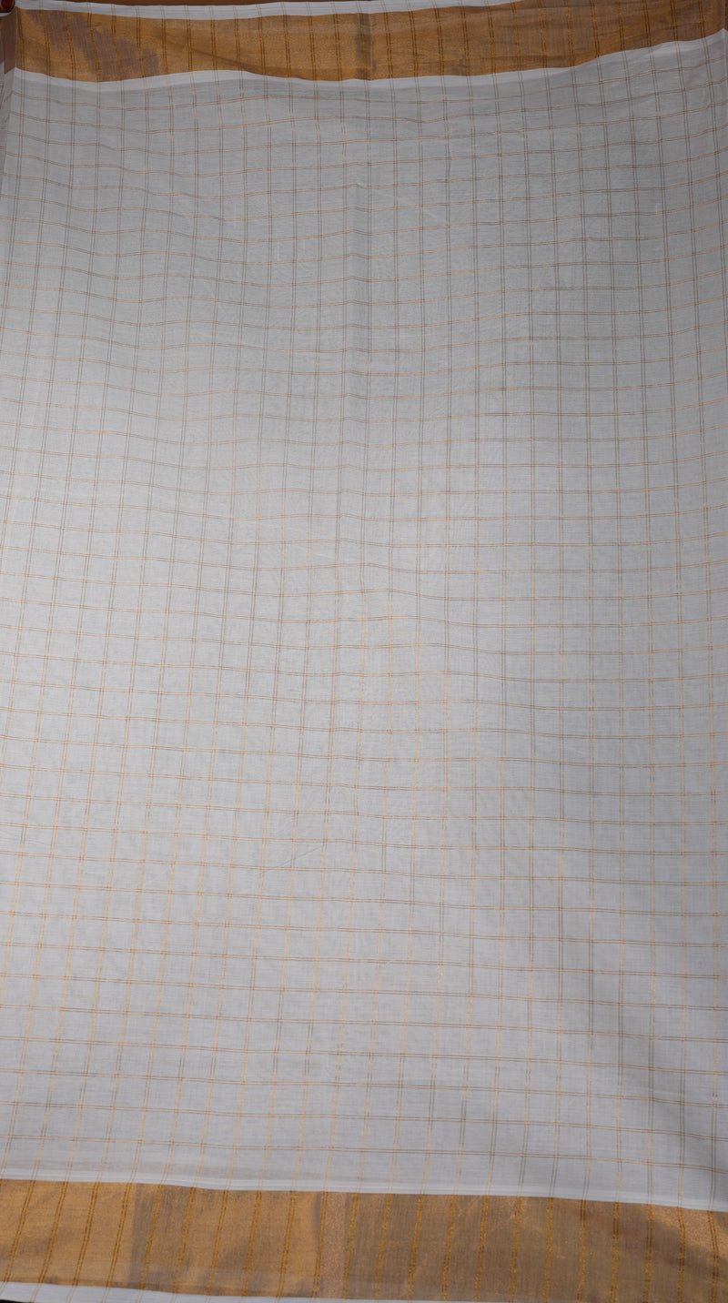 A square white fabric cloth with a fine orange grid pattern and a solid orange border, laid flat on a wooden surface.