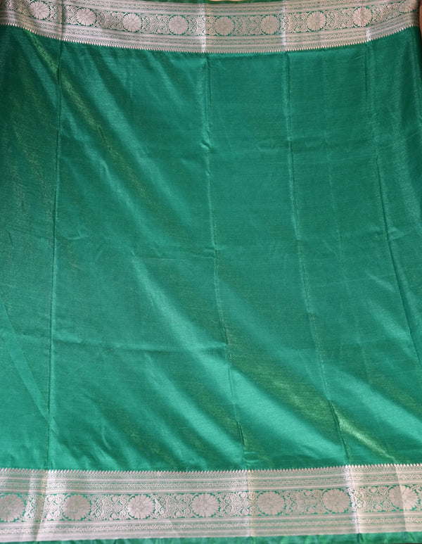 A green silk saree or fabric panel with metallic Gold borders featuring intricate floral patterns.