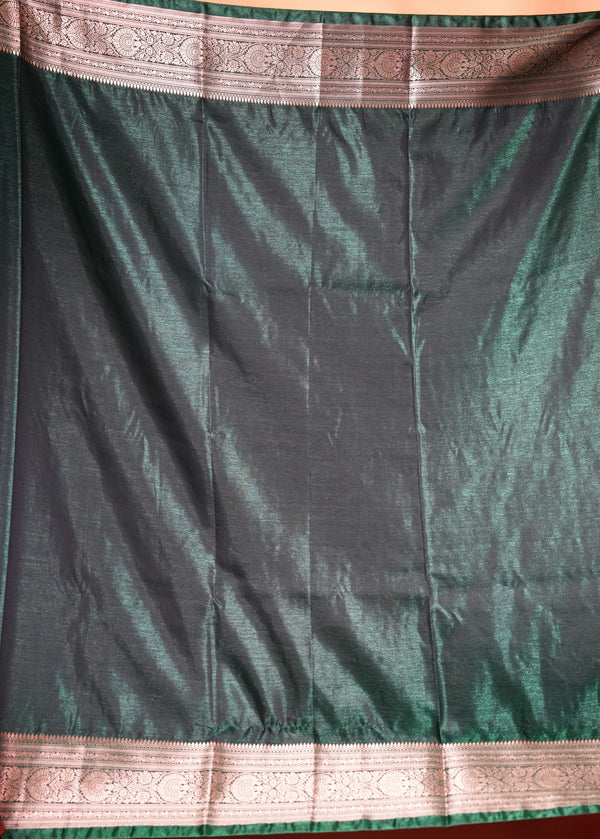 A dark green silk saree or fabric panel with metallic pink borders at the top and bottom, displayed flat.
