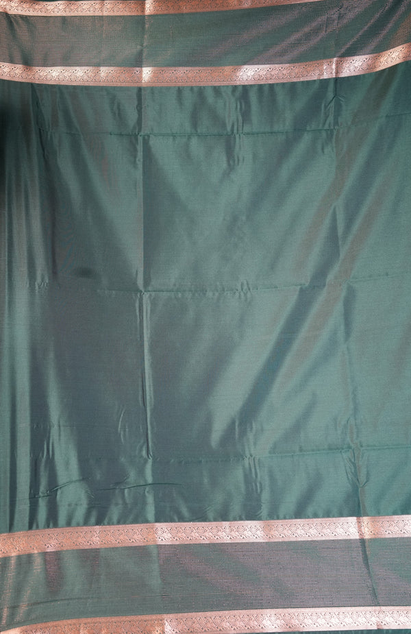 A dark green silk saree fabric with metallic copper-pink borders, shown draped flat.