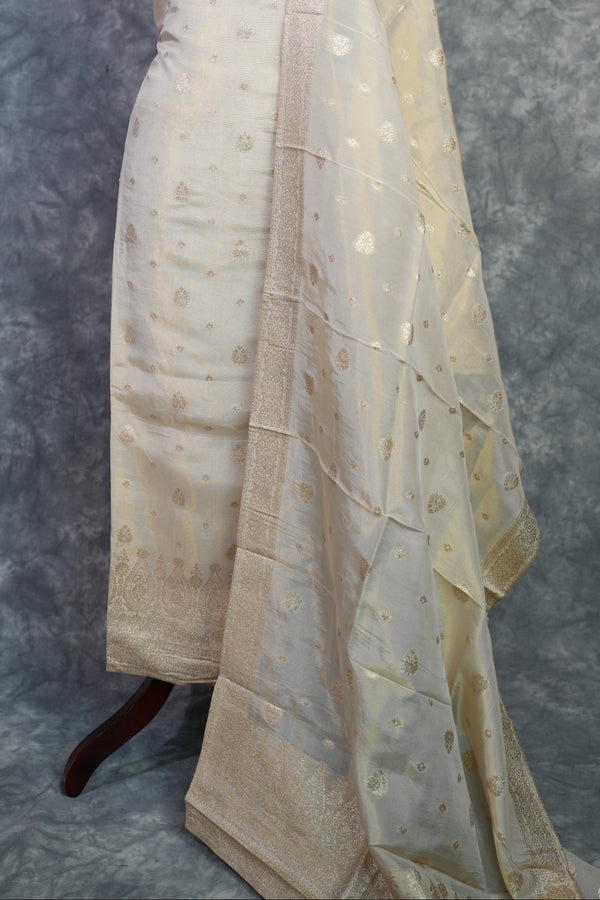 Mannequin wearing a beige dress with a textured pattern on a gray background
