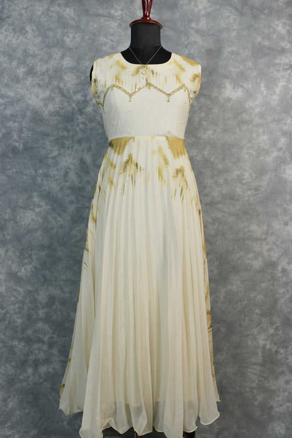 Golden Feather Chiffon Top Set — Cream chiffon with golden feather prints, pearl & stone embellishments on the neckline, flowing pleated skirt. Elegant & festive for special occasions.