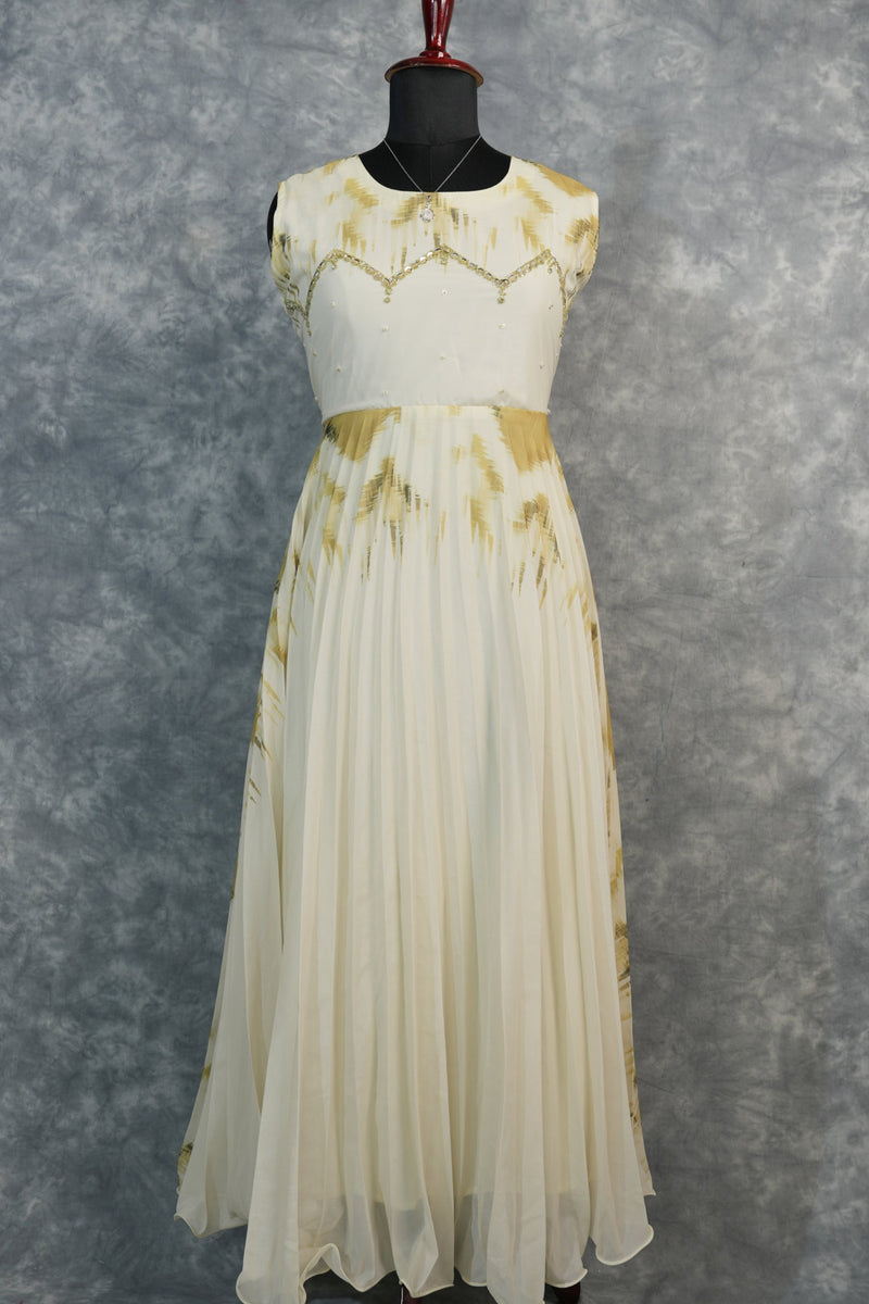 Golden Feather Chiffon Top Set — Cream chiffon with golden feather prints, pearl & stone embellishments on the neckline, flowing pleated skirt. Elegant & festive for special occasions.
